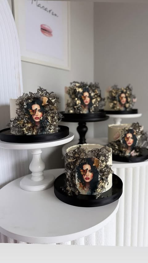 Multiple decorative cakes with edible gold flakes, portrait images of women wearing sunglasses, displayed on white and black cake stands