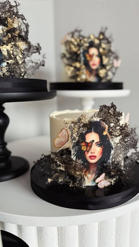 Luxury decorative candles with black and gold textured crackle finish and portrait imagery on white tiered display pedestals